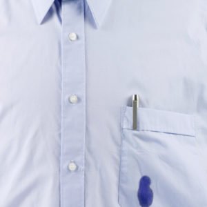 Close-up of blue shirt with ink stain on pocket